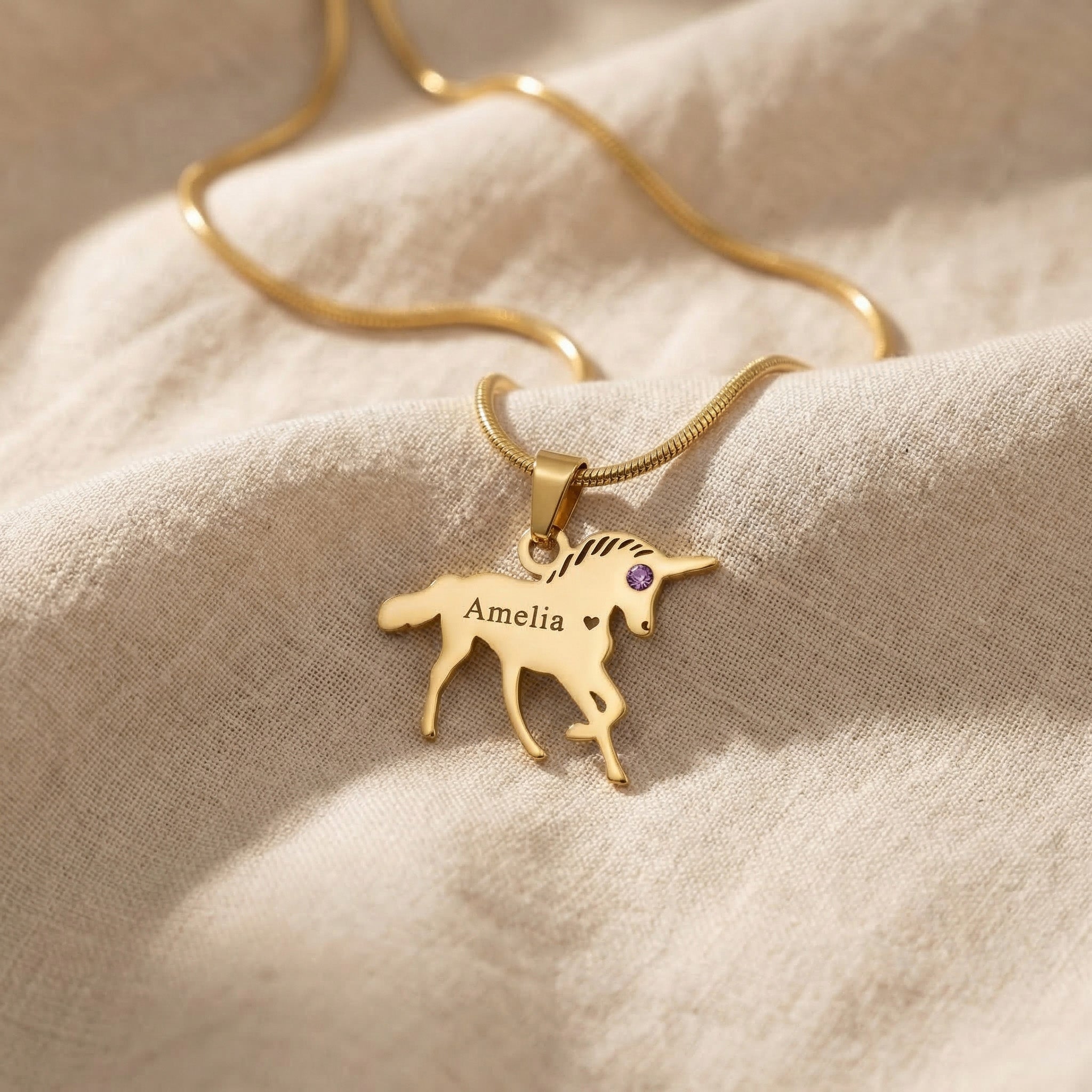 Unicorn name necklace in gold with personalised name and playful unicorn design