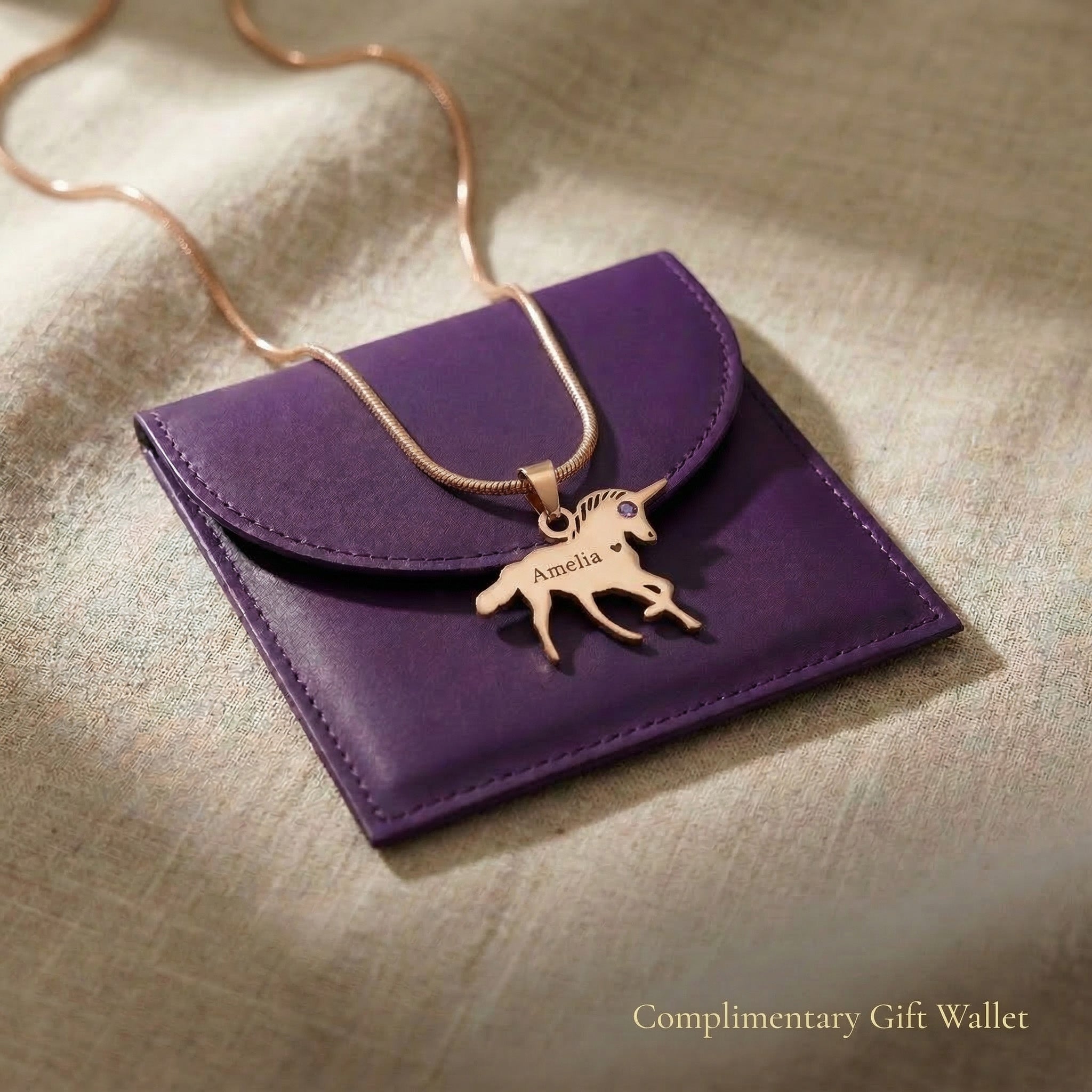 Unicorn name necklace displayed with gift wallet packaging, kids jewellery gift option